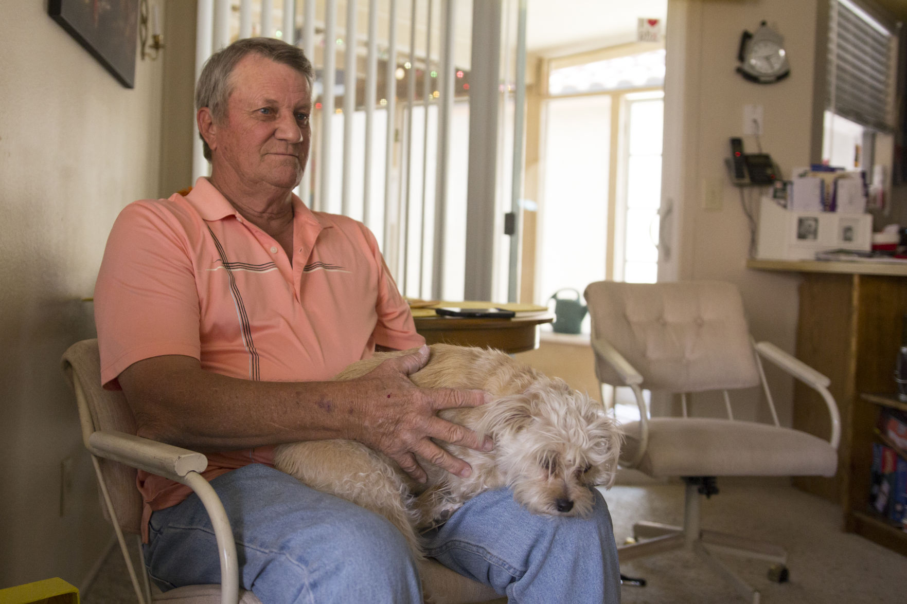 Fluffy, taking a nap on Bob Dentz’s lap. She and her sister Boots live with him these days because Dentz wants to spare his mother any more problems with a complaining neighbor.